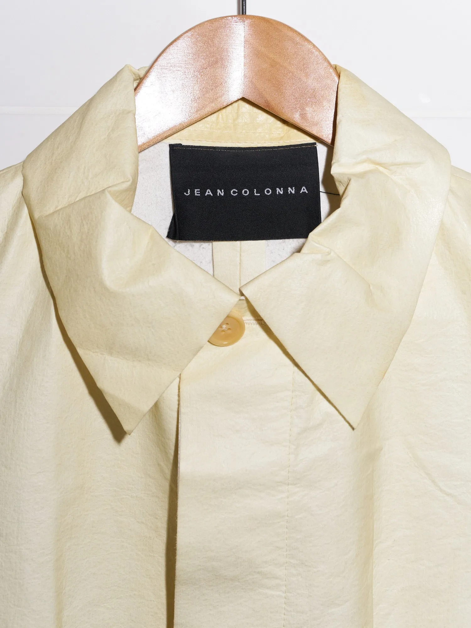 Jean Colonna cream paper-y vinyl covered placket coat - size 38